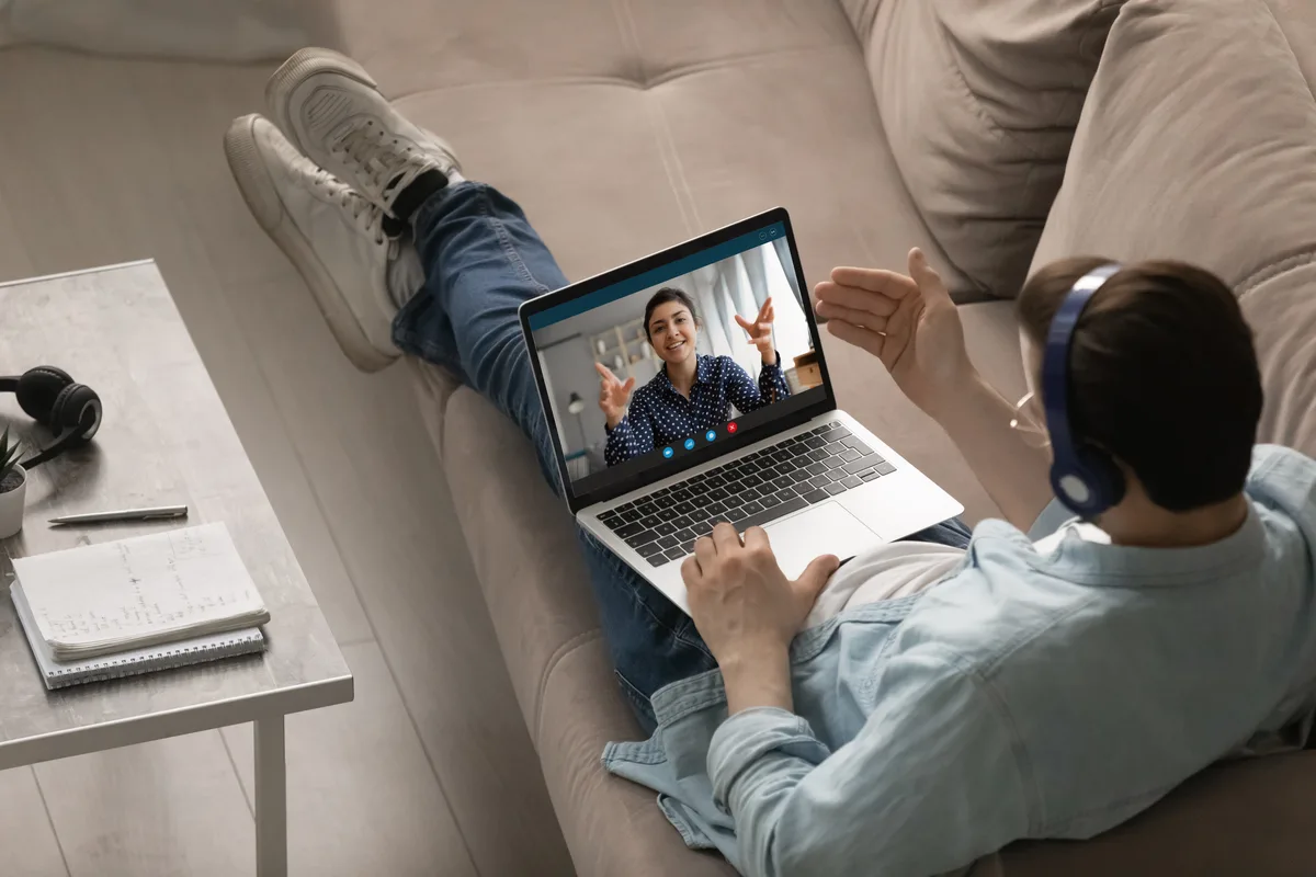 Person on a video therapy call, relaxed at home